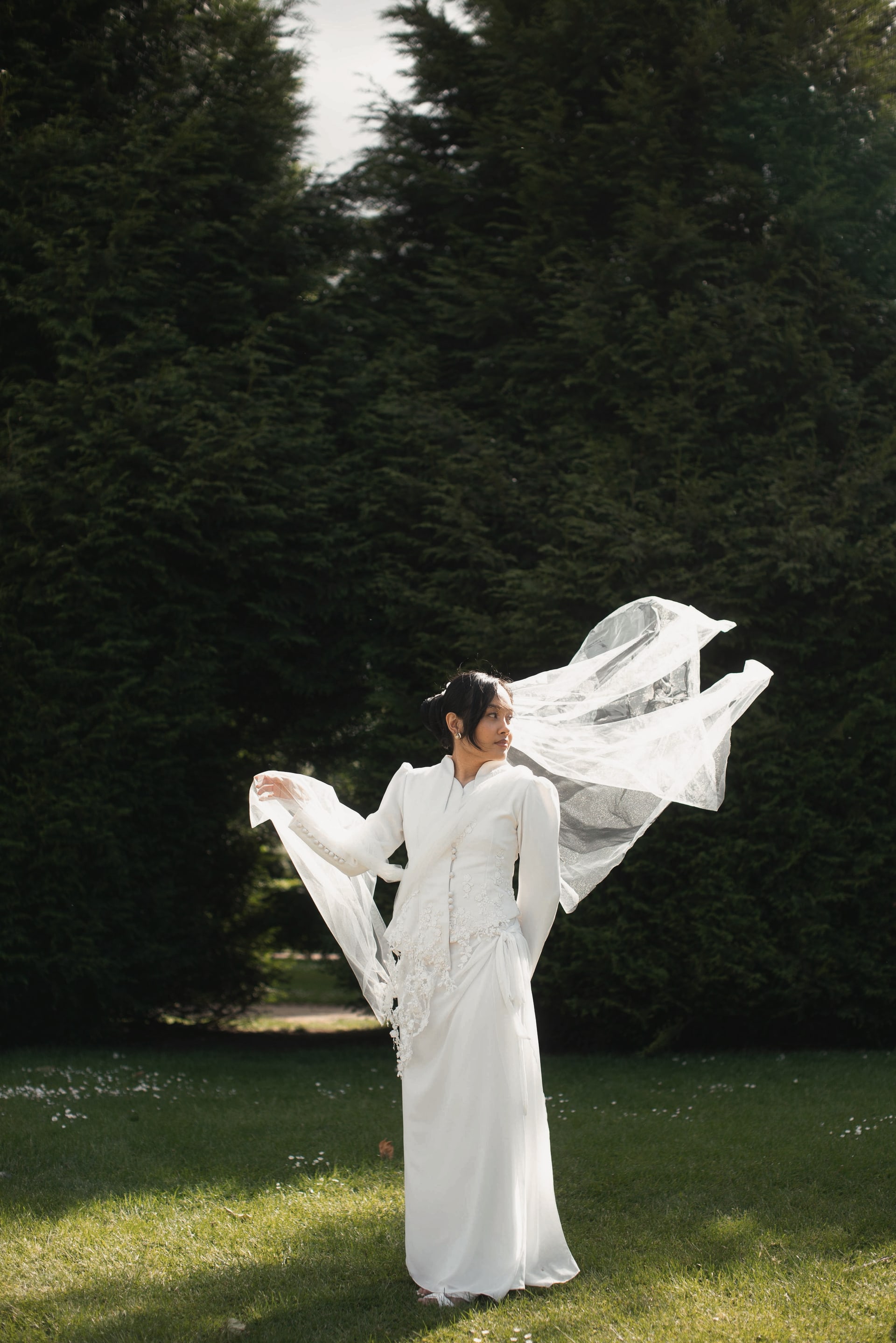 A bride in a clean one-shoulder ball gown.